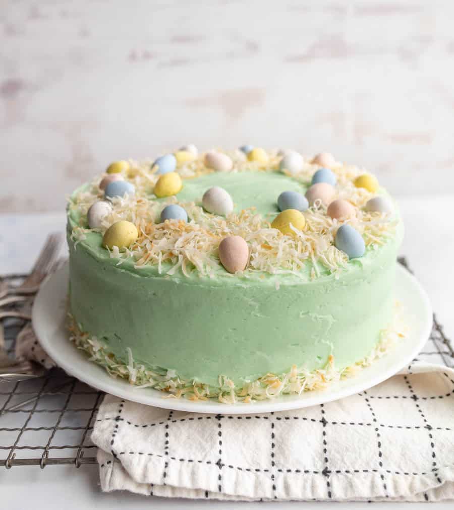 whole decorated easter coconut cake and the coconut shreds make a nest for candy eggs