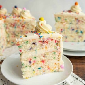 slice of funfetti sprinkle cake on a white plate