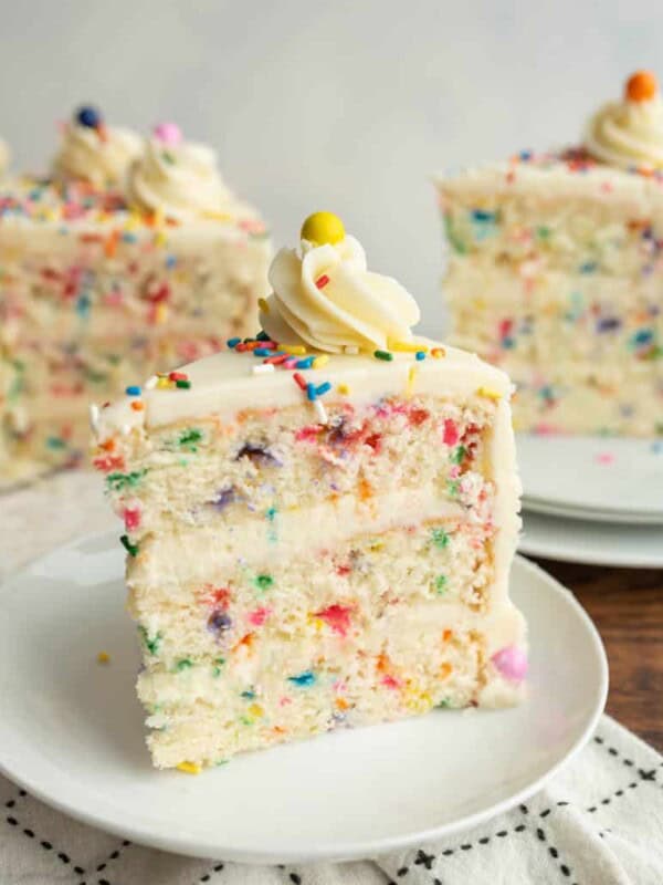 slice of funfetti sprinkle cake on a white plate