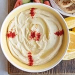 bowl of hummus with red spice on top