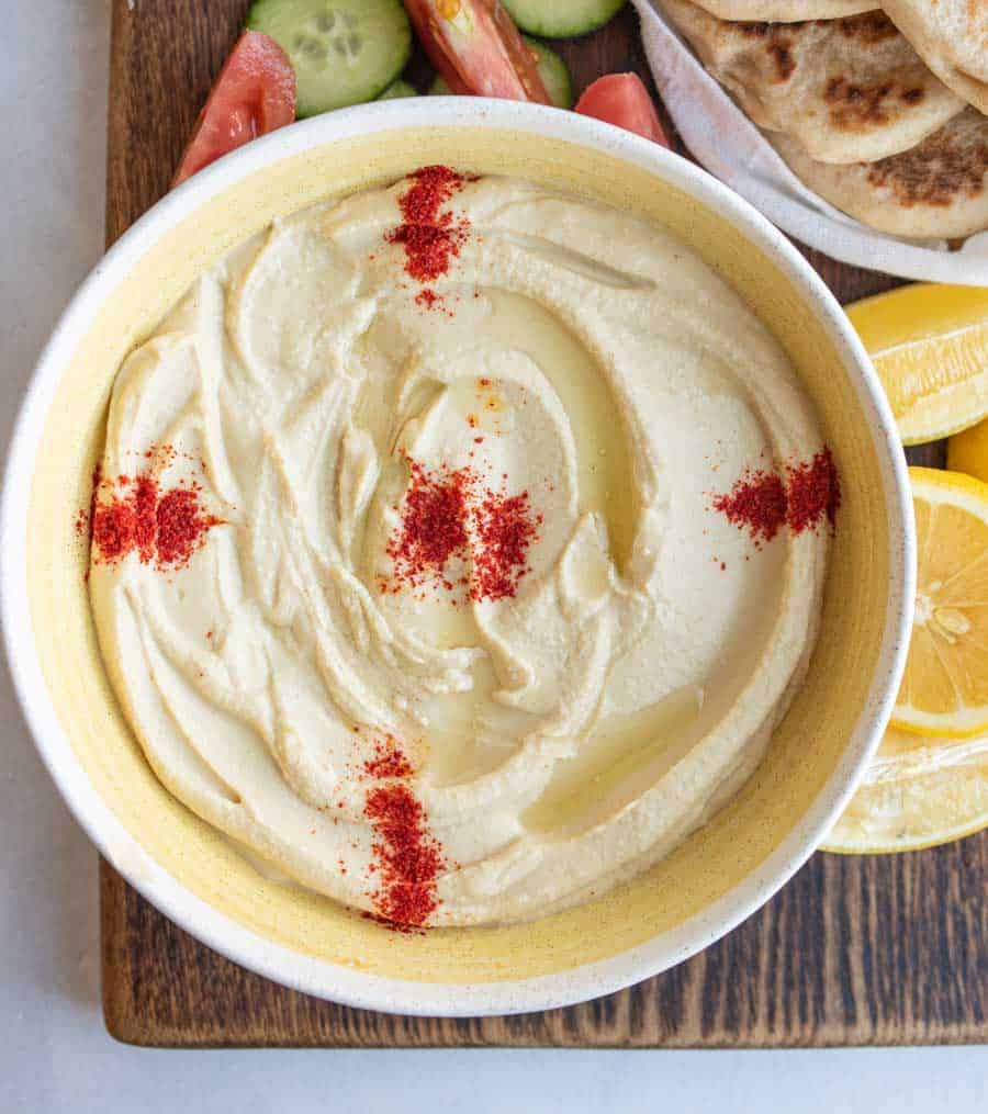 top view of hummus in yellow bowl 