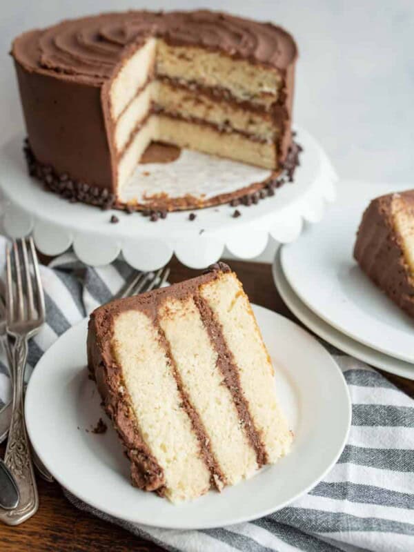 White Cake with chocolate icing with two servings wedged out onto white plates