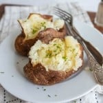 plated air fried baked potato with butter and herbs