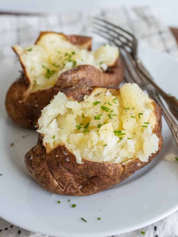 plated air fried baked potato with butter and herbs