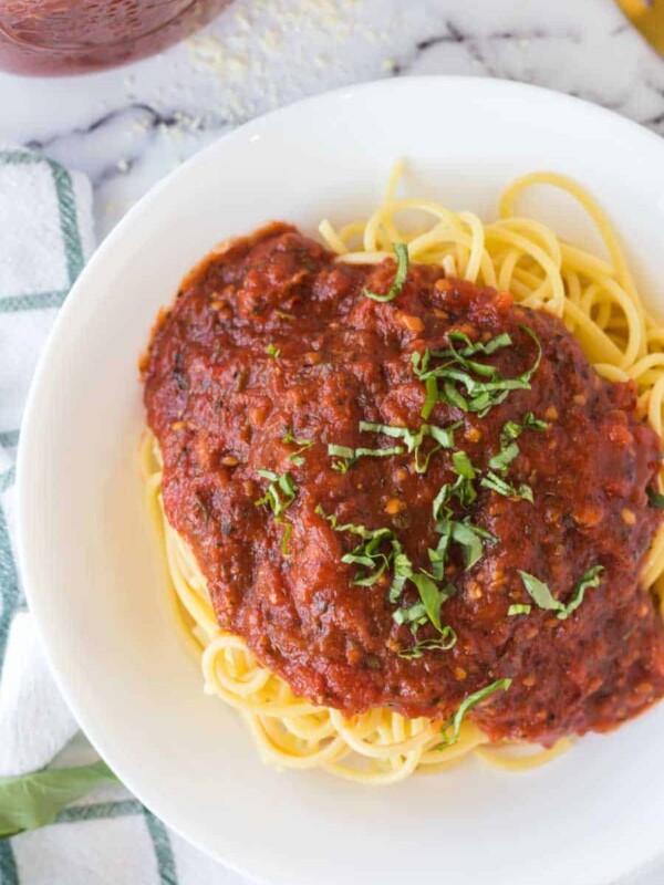 arrabbiata sauce over pasta on a white plate