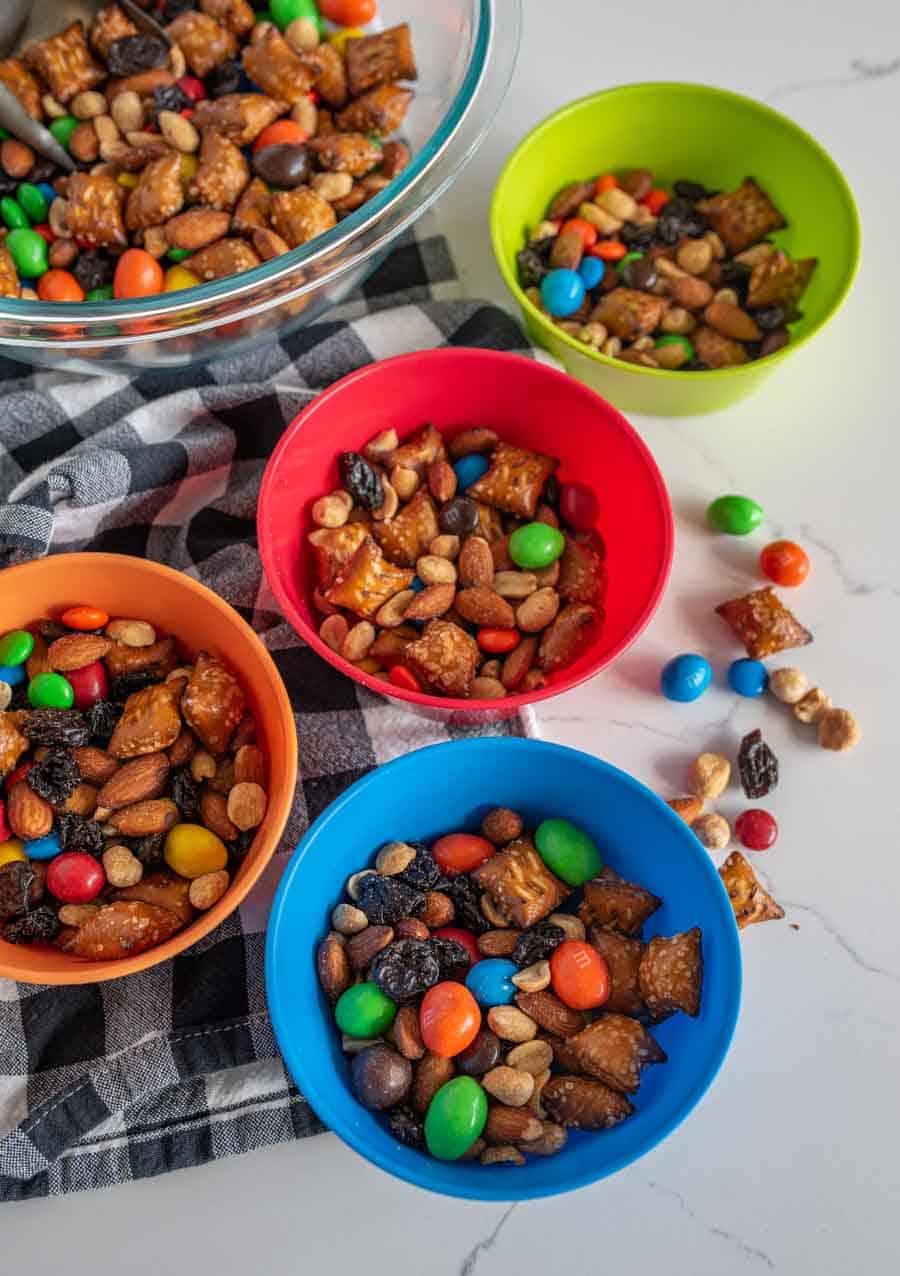 multi colored bowls filled with trail mix