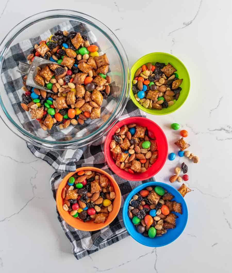 multi colored bowls filled with trail mix