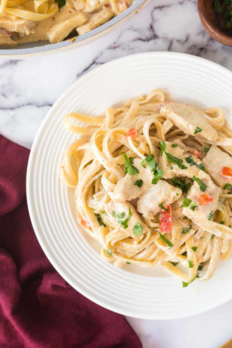 cajun chicken pasta served on a white plate