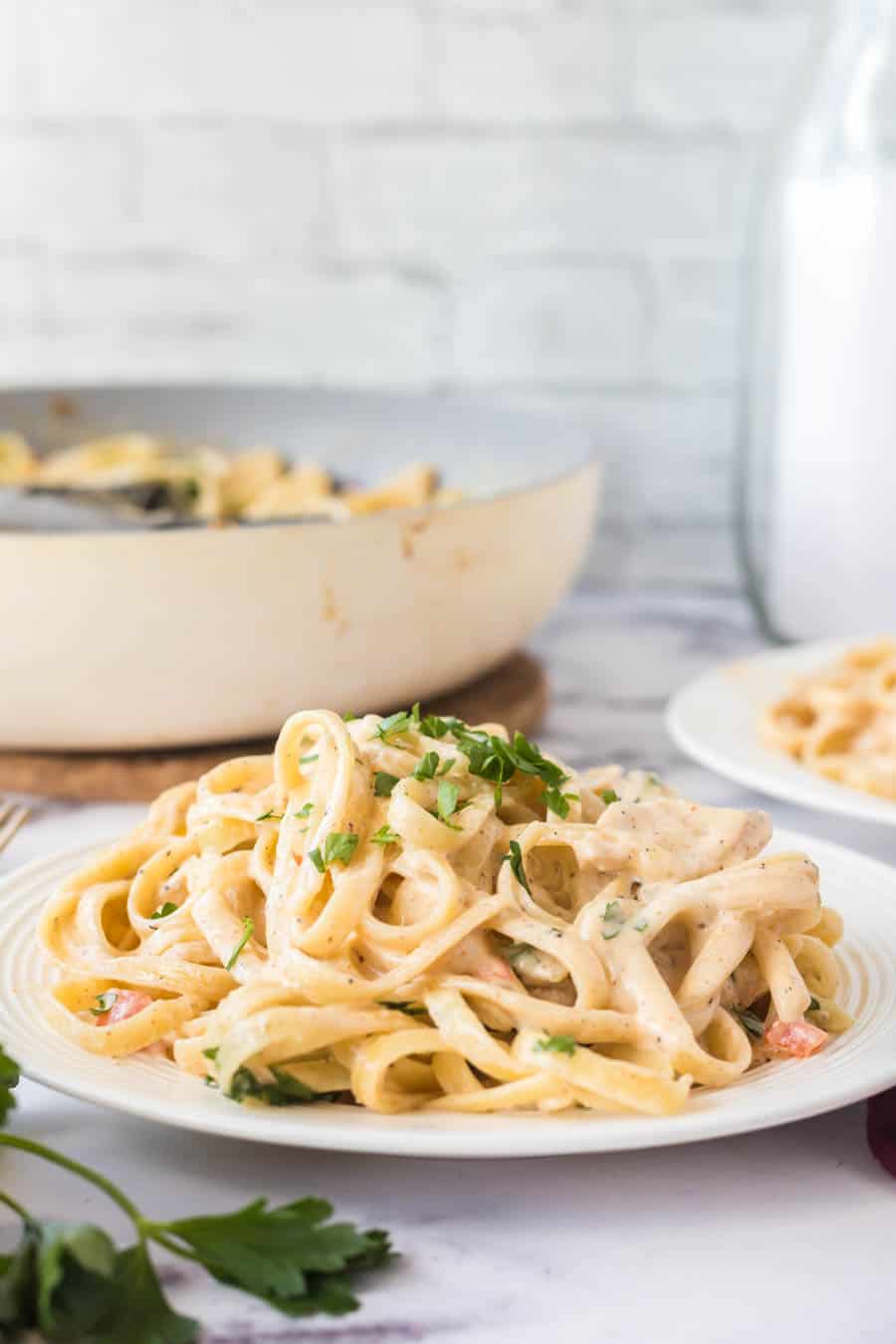 cajun chicken pasta side view on a white plate
