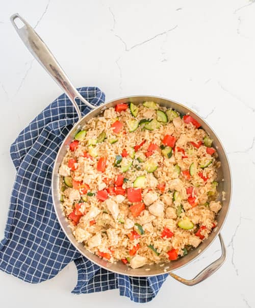 chicken and rice with zucchini in the pan