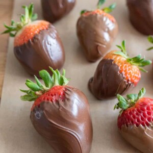 close up chocolate covered strawberries on parchment paper