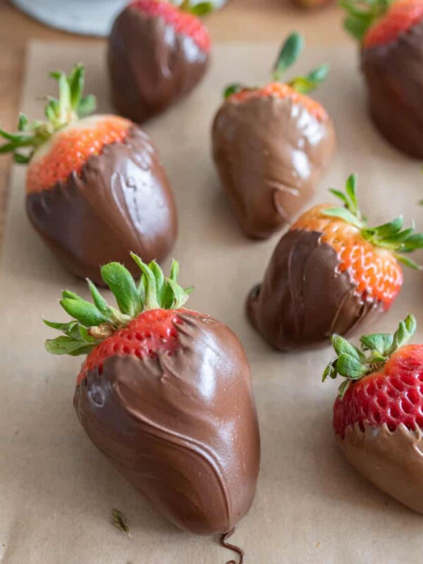 close up chocolate covered strawberries on parchment paper