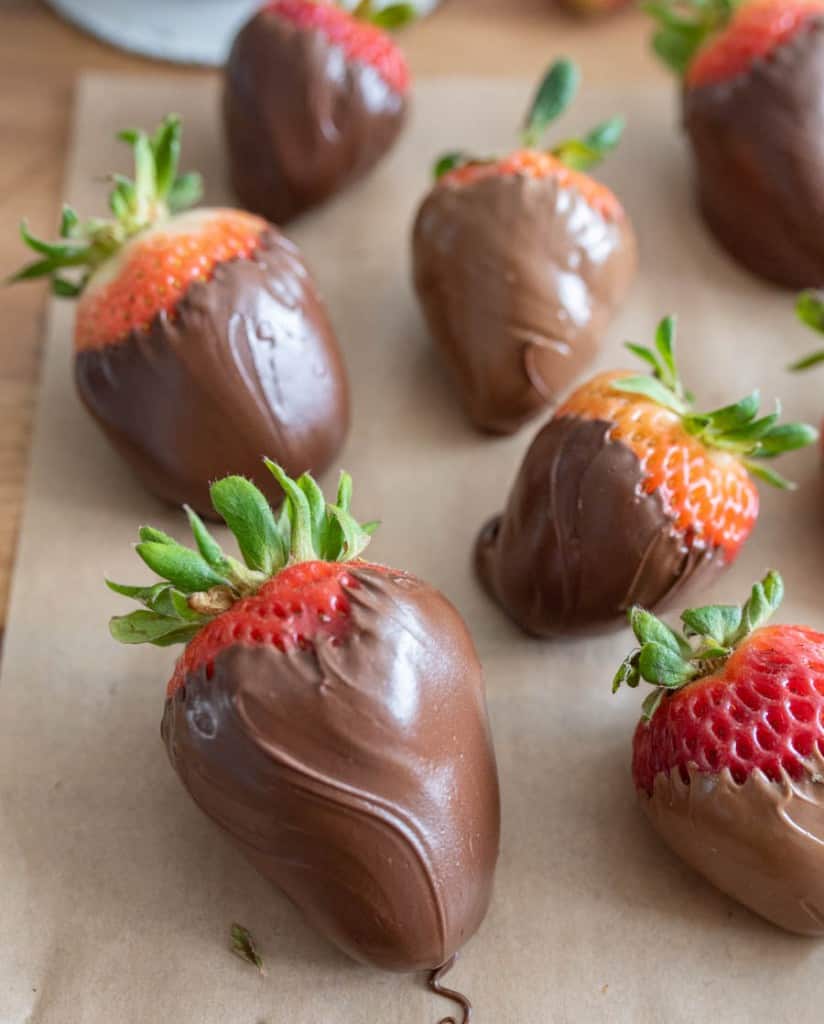 close up chocolate covered strawberries on parchment paper