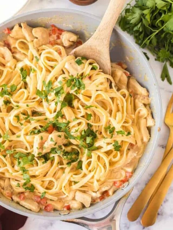 cajun chicken pasta with a wooden spoon in the pan from the top view