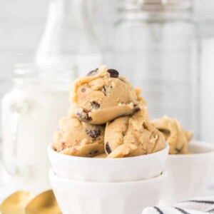 white bowls of round scoops of edible cookie dough