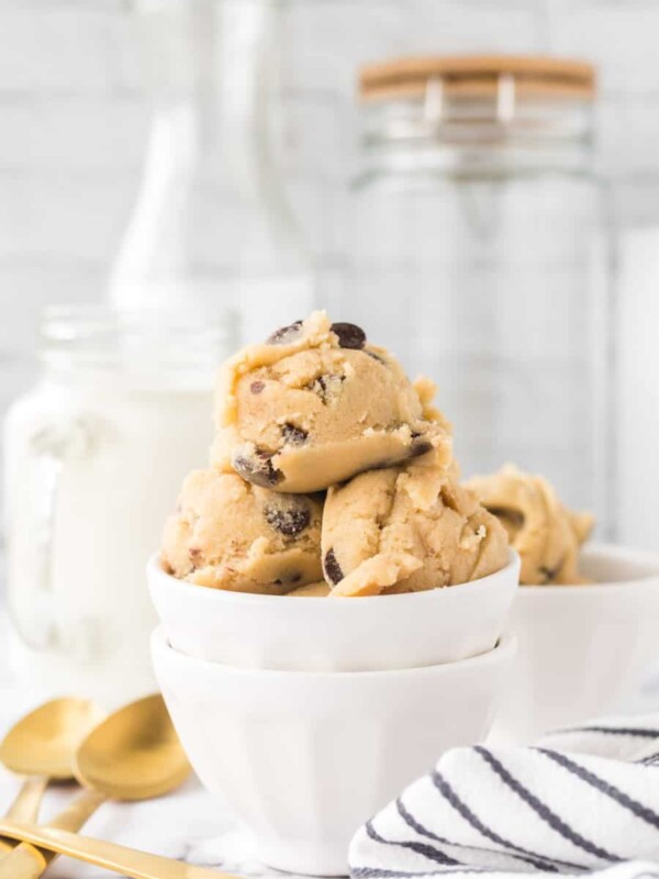 white bowls of round scoops of edible cookie dough