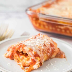 lasagna roll up served on a white plate