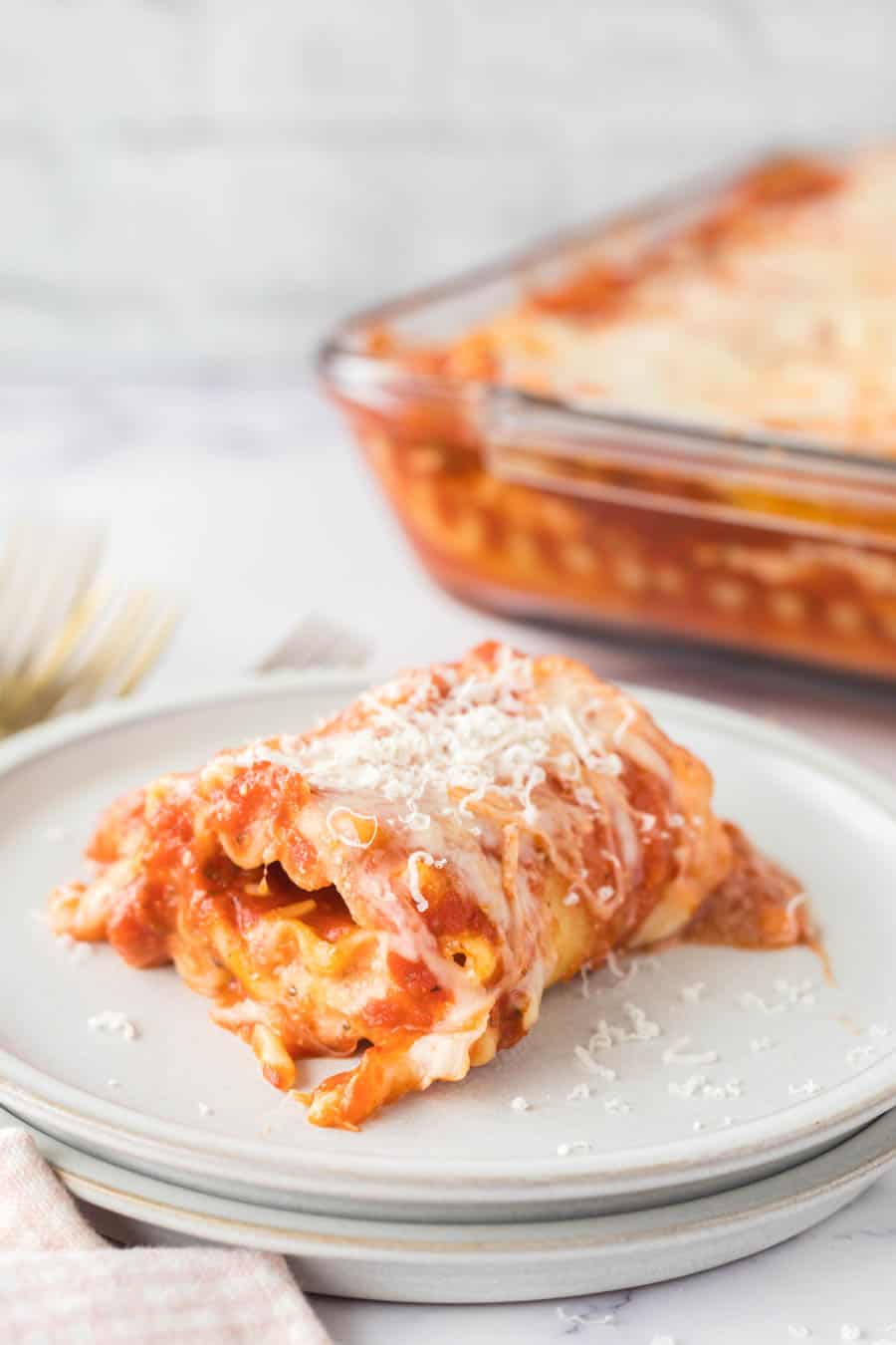 lasagna roll up served on a white plate