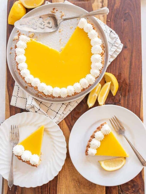 top view of lemon tart with servings dished onto white plates