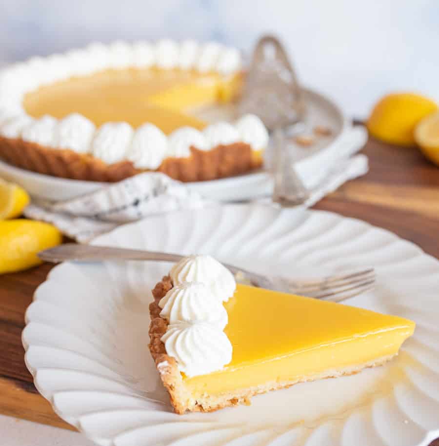 lemon tart with servings dished onto white plates