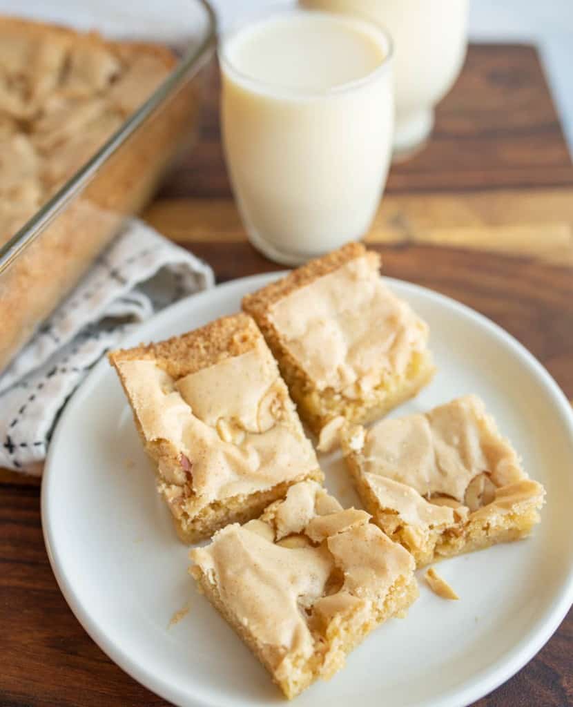 peanut butter brownies into serving sized bites on a white plate