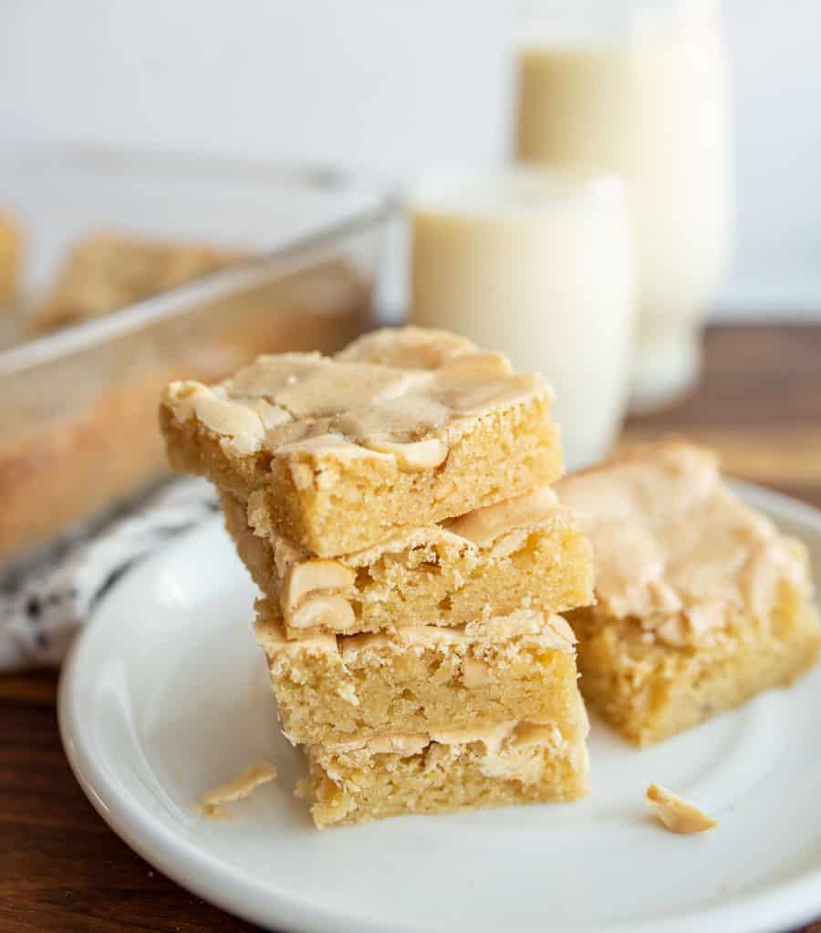 peanut butter brownies in a stack on a white plate