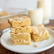 peanut butter brownies in a stack on a white plate