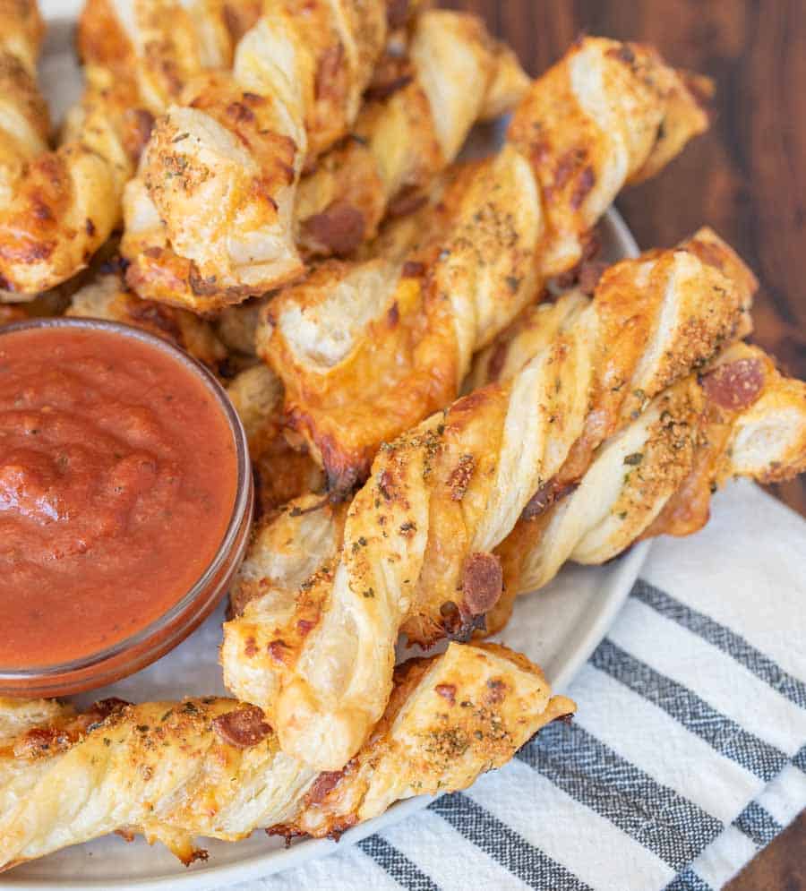 plate of pizza twists with marina dipping sauce in the middle