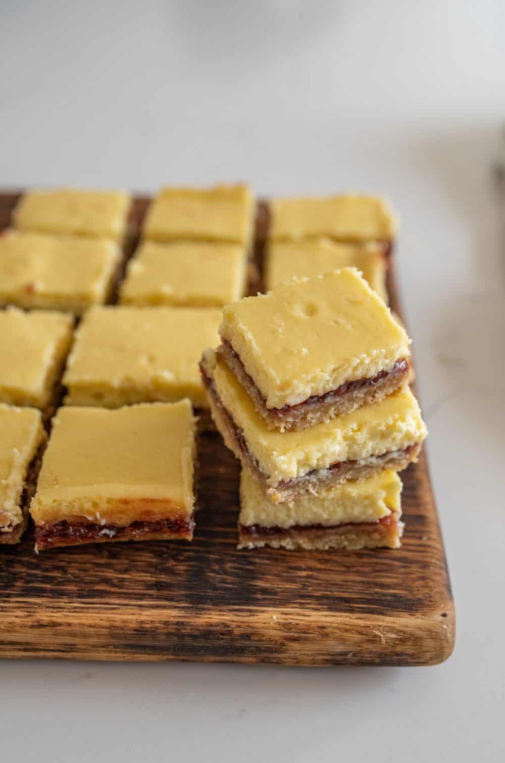 wooden board with raspberry cheesecake bars