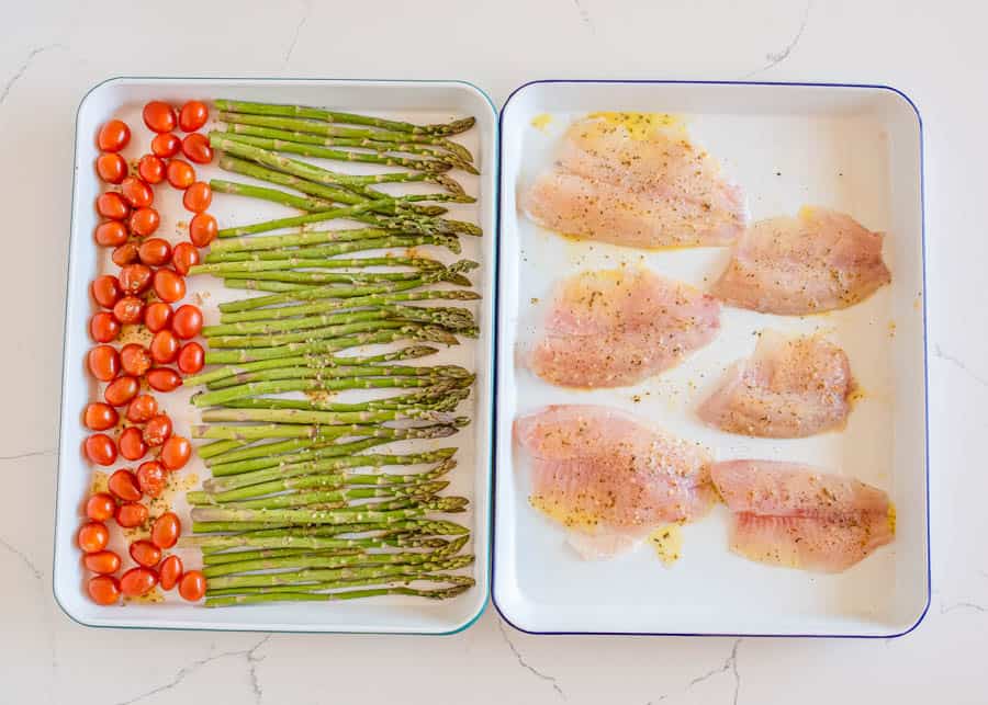 sheetpan tilapia and veggies raw on the pans