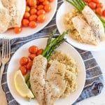 sheetpan tilapia and veggies dinner served on plates