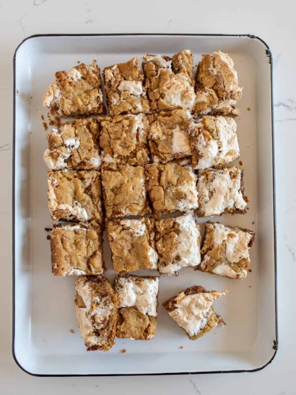 smores cookie bars cut into squares and on a white plate