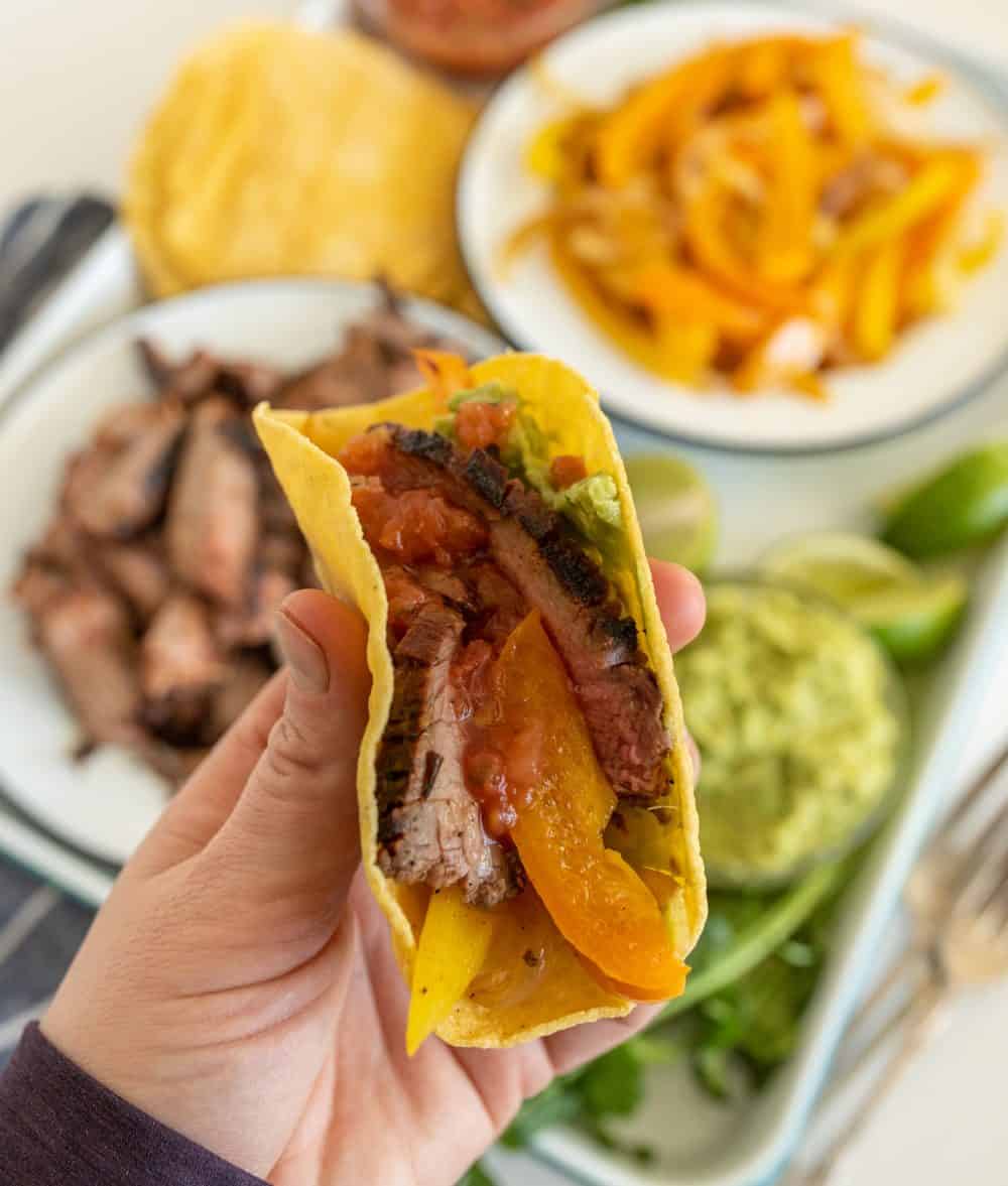 POV Image of a hand holding a steak fajita