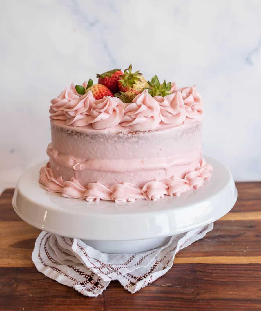 a strawberry cake with strawberry buttercream