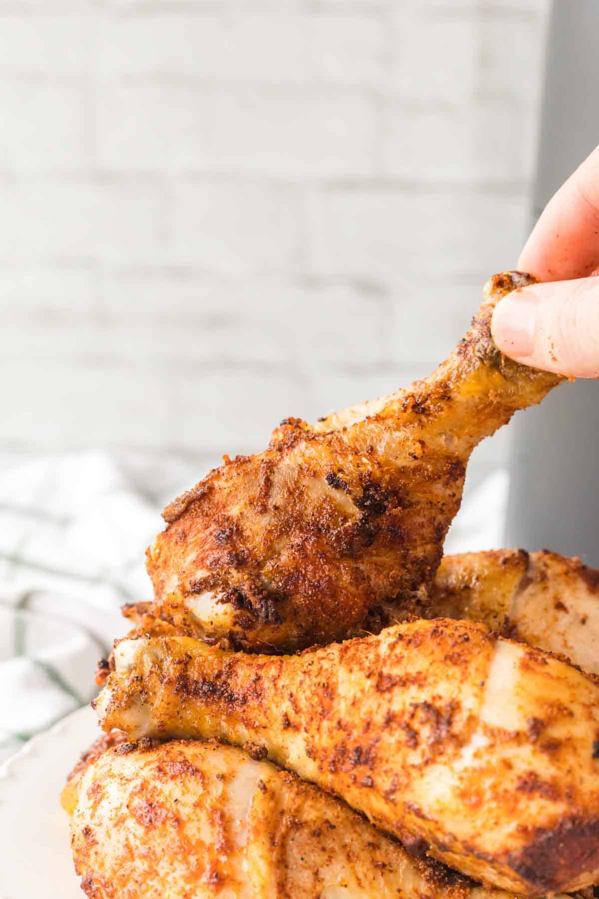 close up of air fryer chicken legs and their crispy brown skin