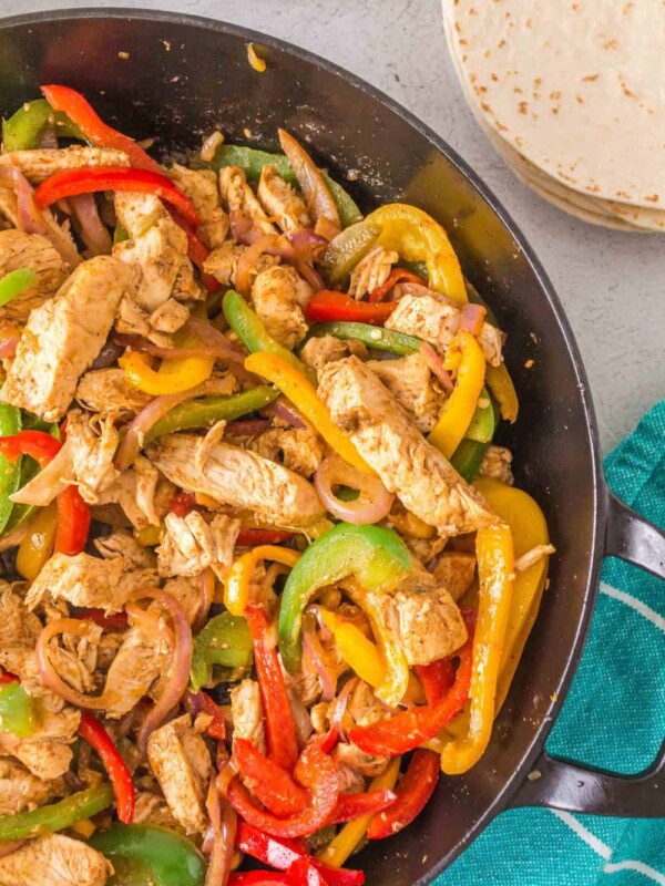 Chicken fajitas with onions and bell peppers in a pan