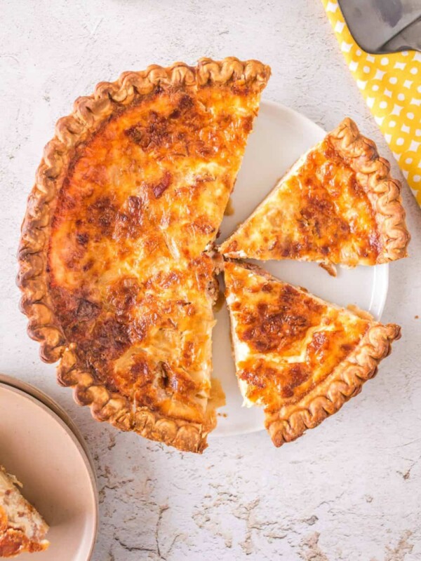 quiche lorraine sliced into portions on a plate top view