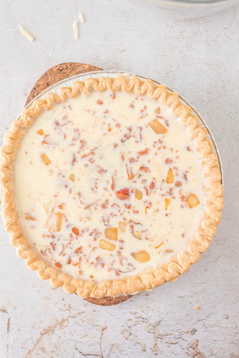 top view of a whole unbaked quiche lorraine