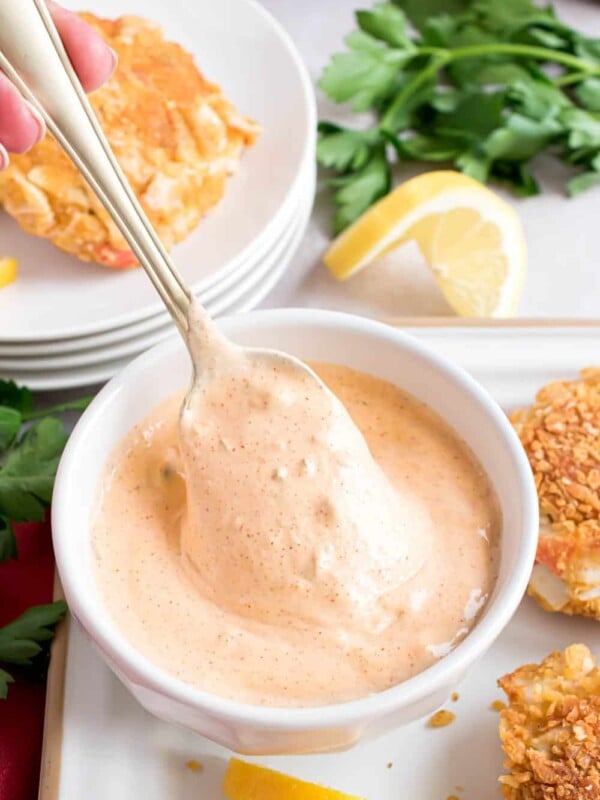 spoon inside of a white bowl of remoulade sauce