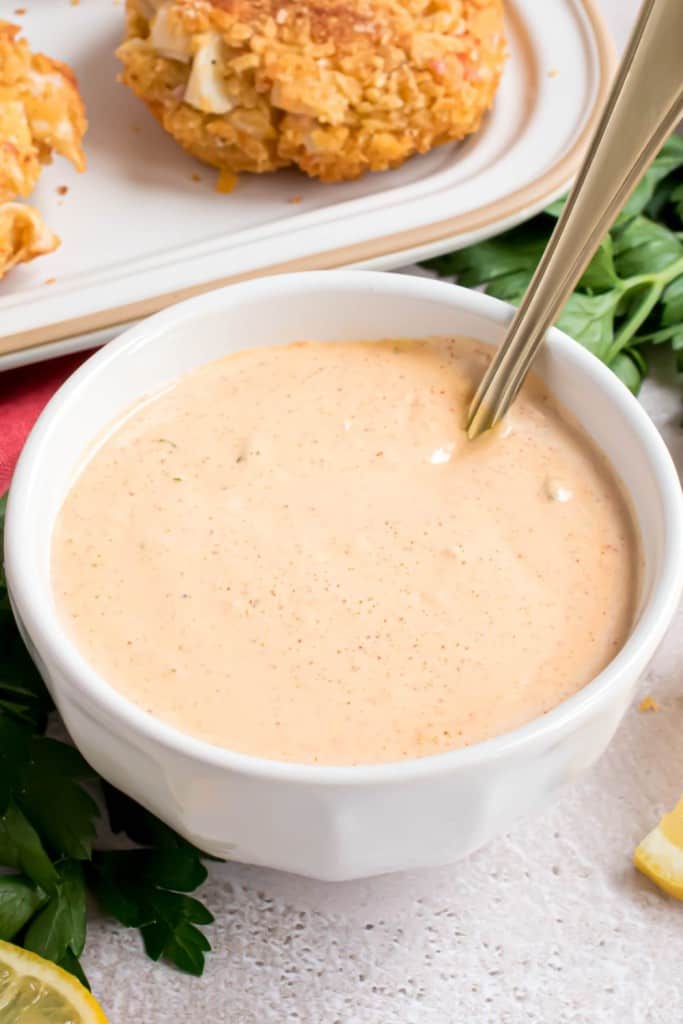 white bowl of remoulade sauce with a spoon in it