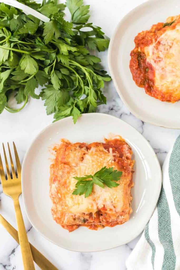 top view of one square serving of lasagna on a white plate