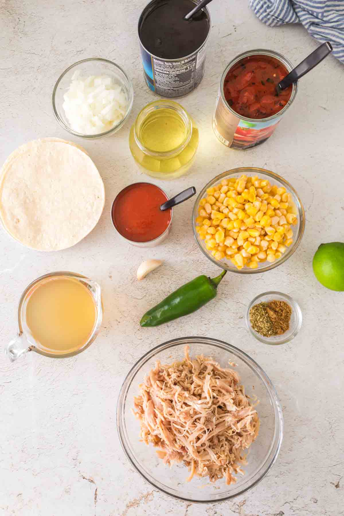 raw ingredients for chicken tortilla soup in portioned dishes