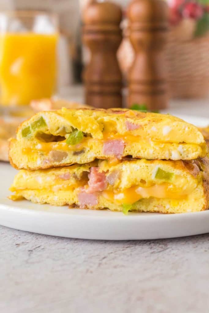 cooked denier omelet cut in half to see the cheesy inside