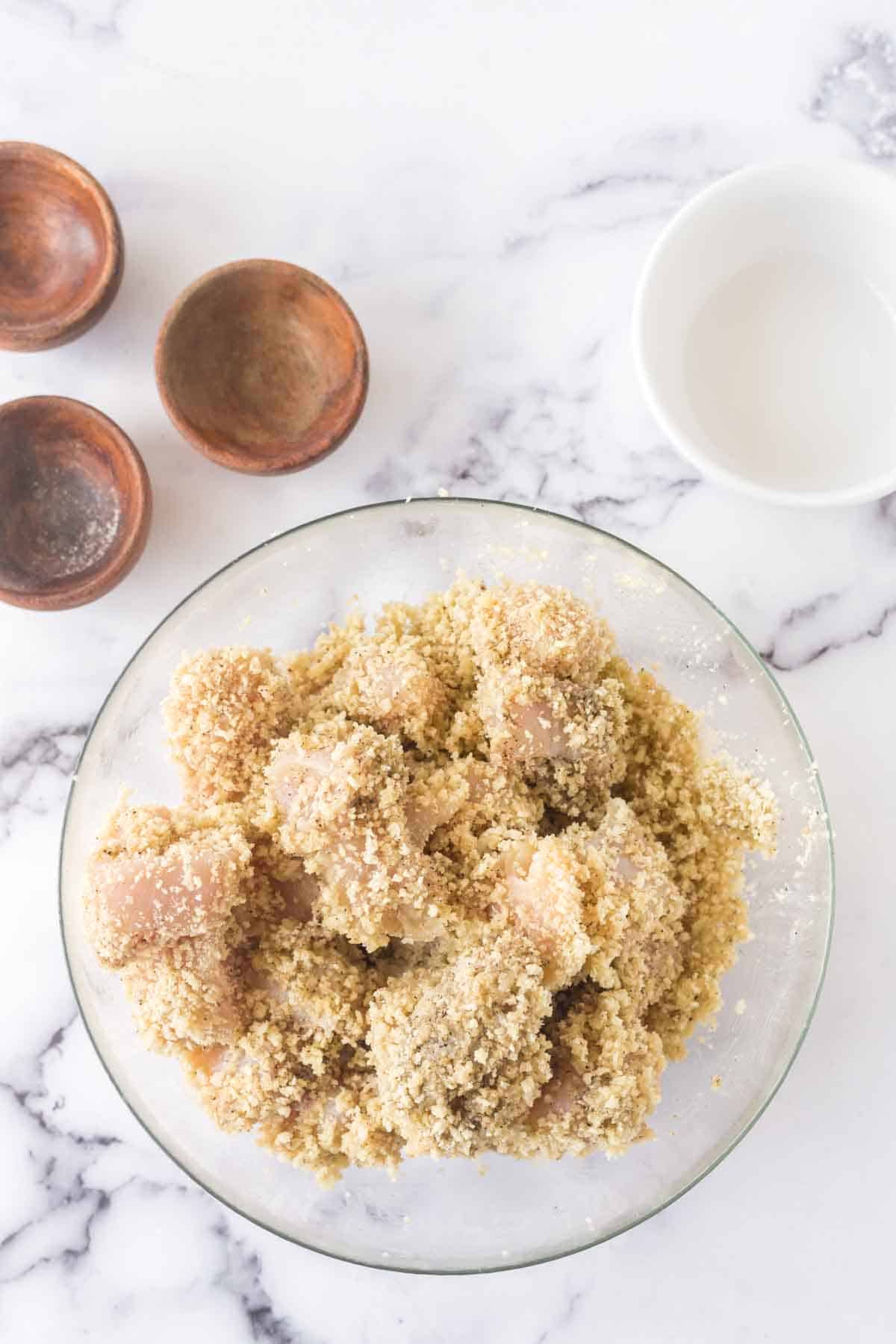 raw chicken pieces in the batter and crust