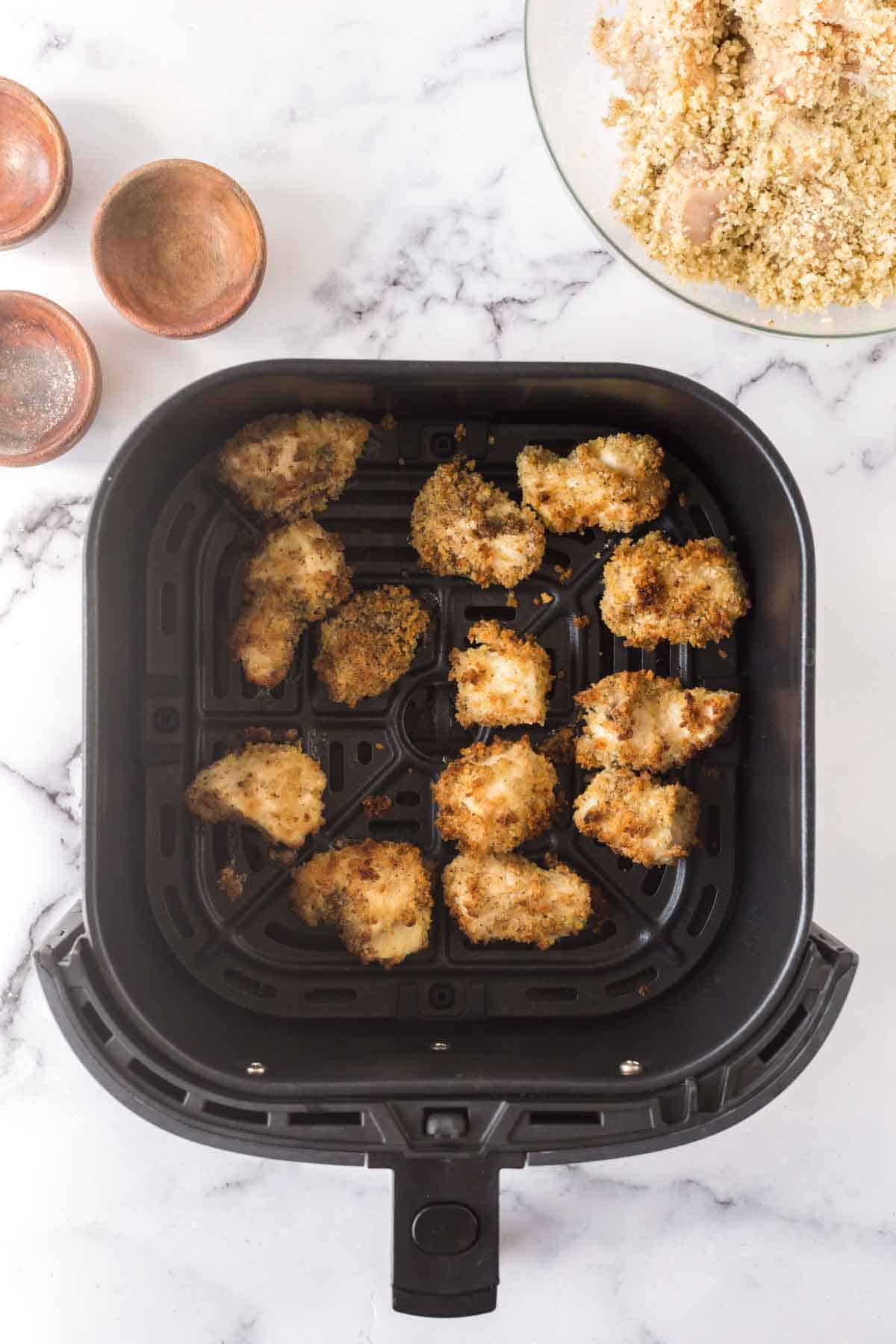 air fryer chicken nuggets in the basket golden brown