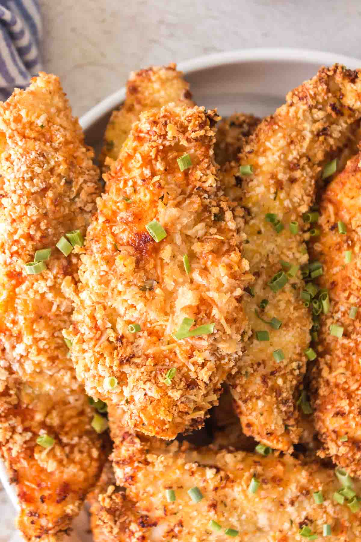 up close plate of golden air fryer chicken tenders