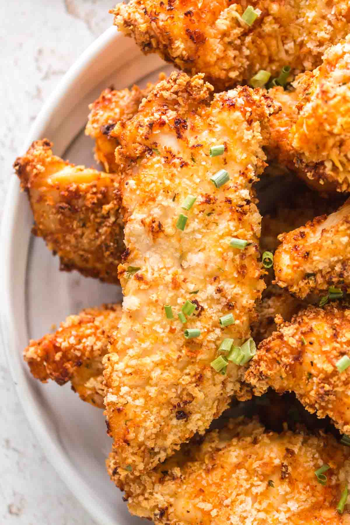 close up plate of golden air fryer chicken tenders