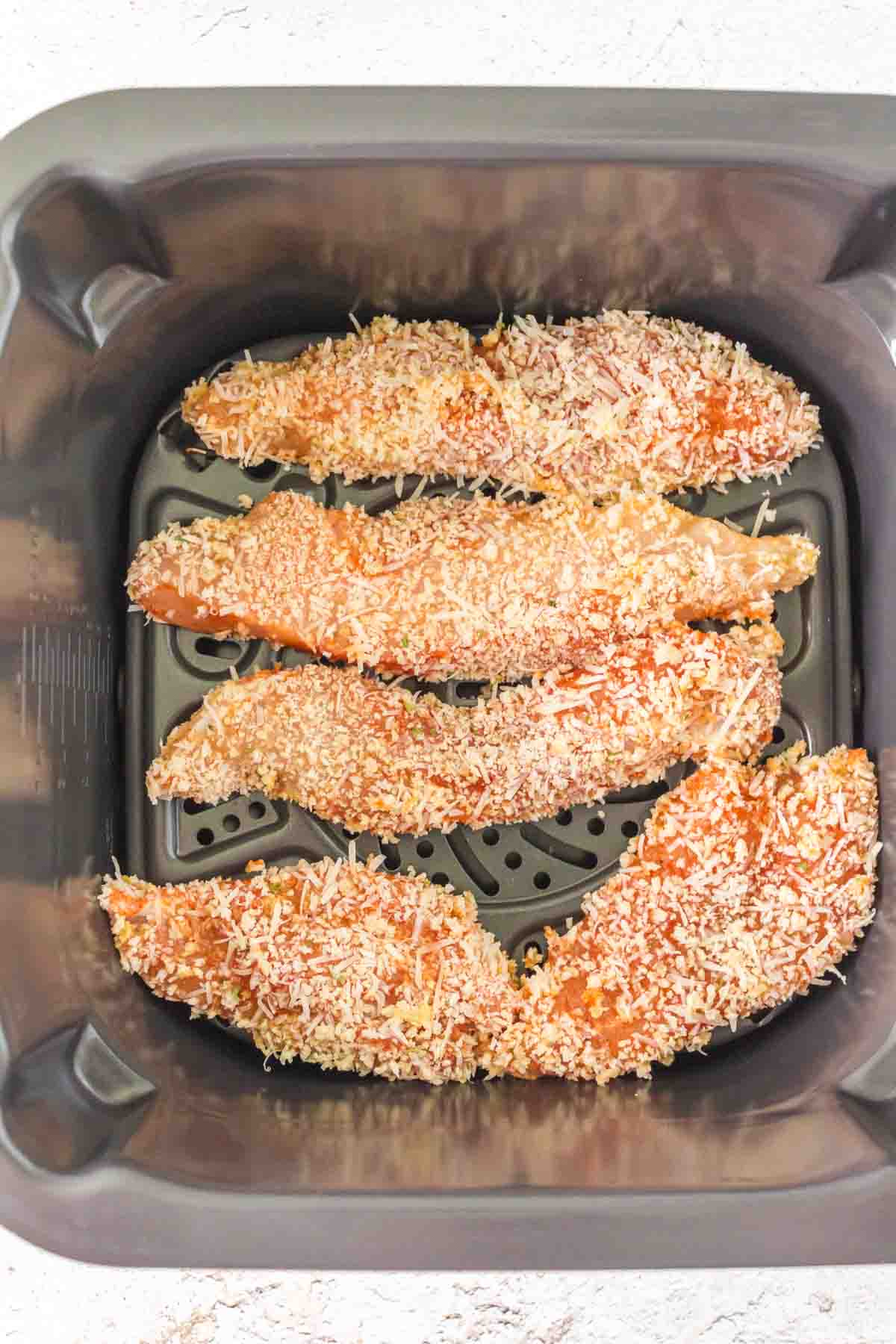 raw and breaded chicken in the air fryer