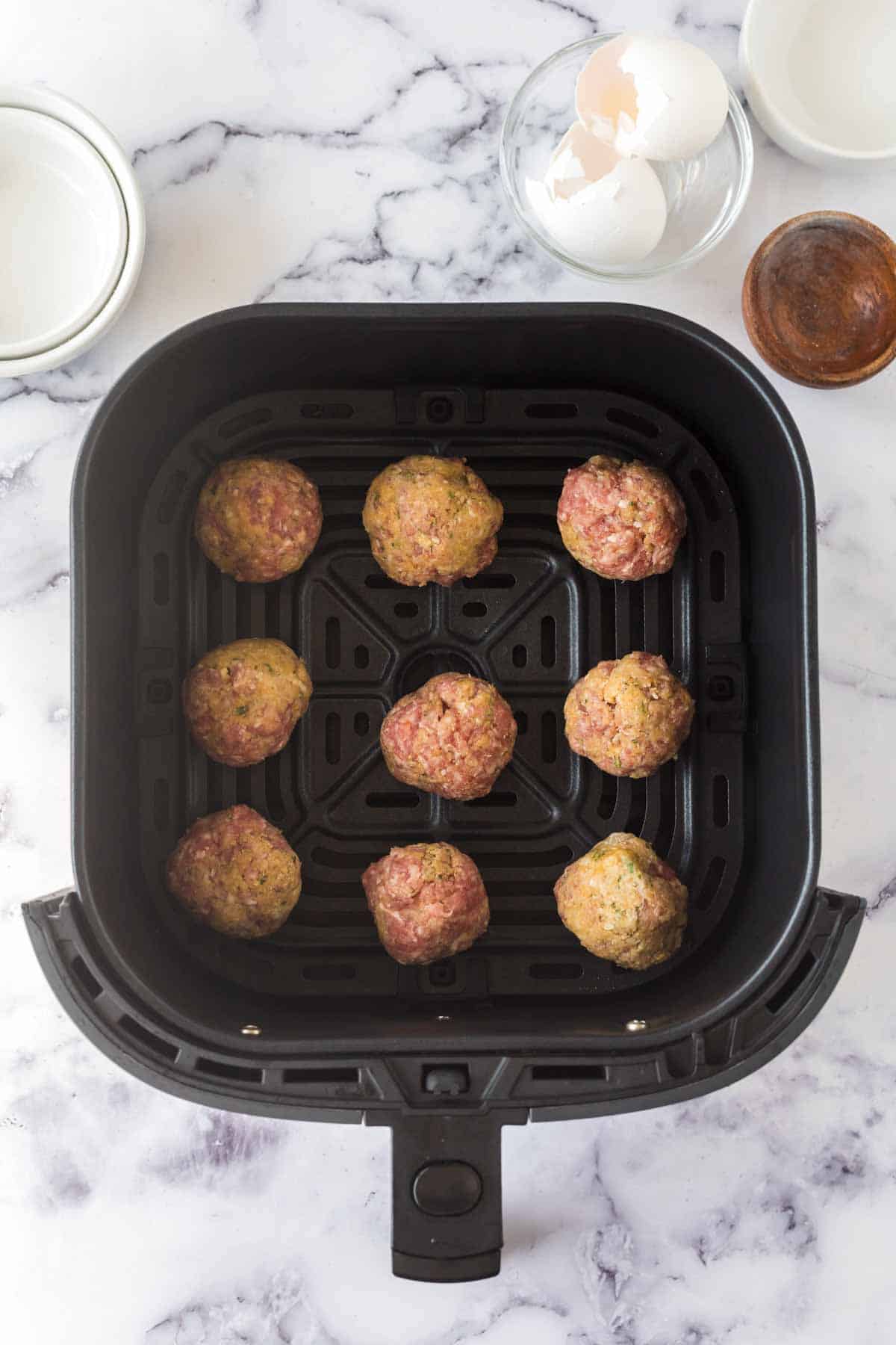 Meatballs in the air fryer ready to be cooked.