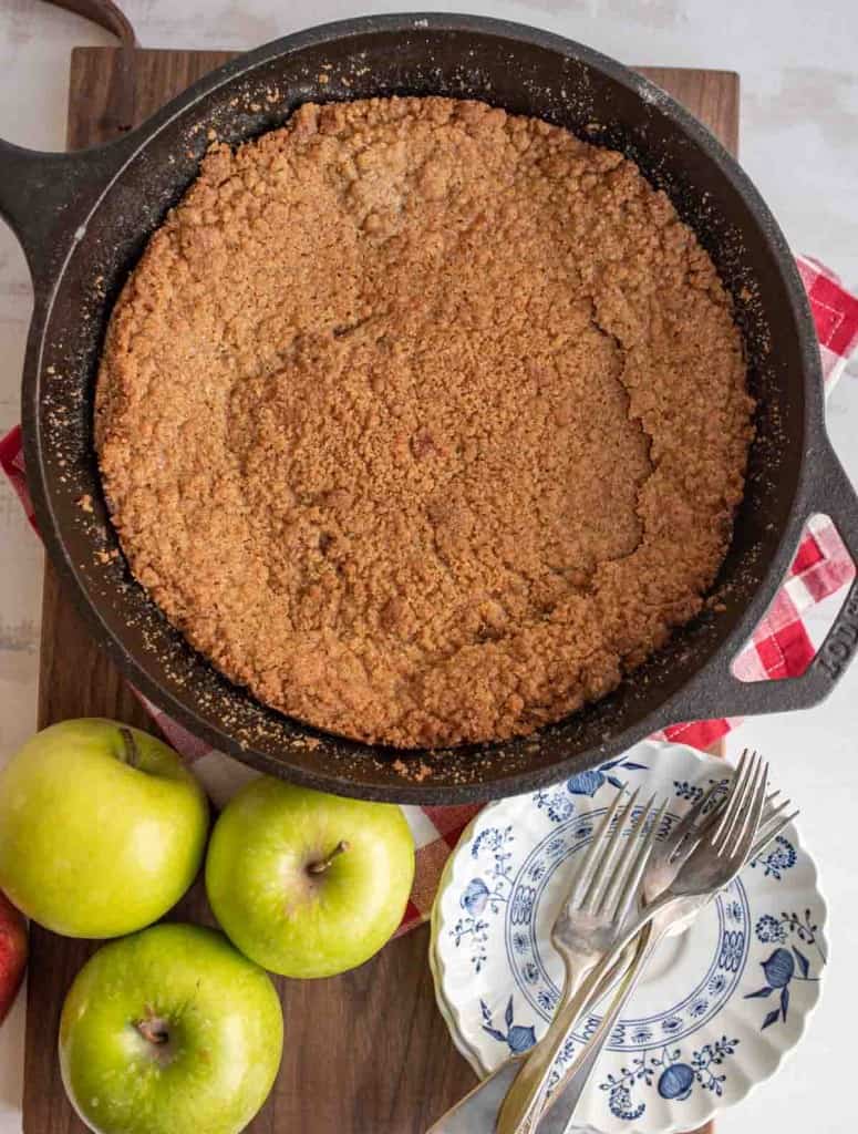top view of whole apple crumble in a cast iron pan